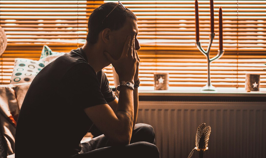 person sitting alone thinking